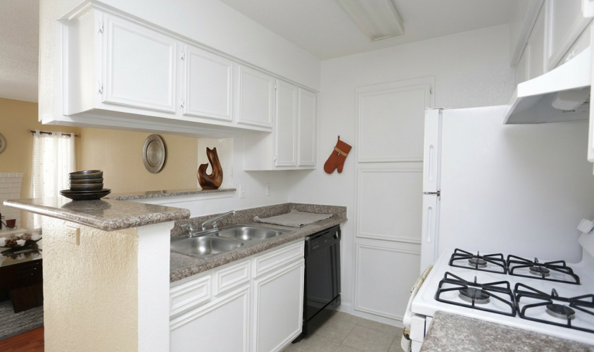 Kitchen with granite countertops at Falls of Kirkwood apartments in Houston, TX