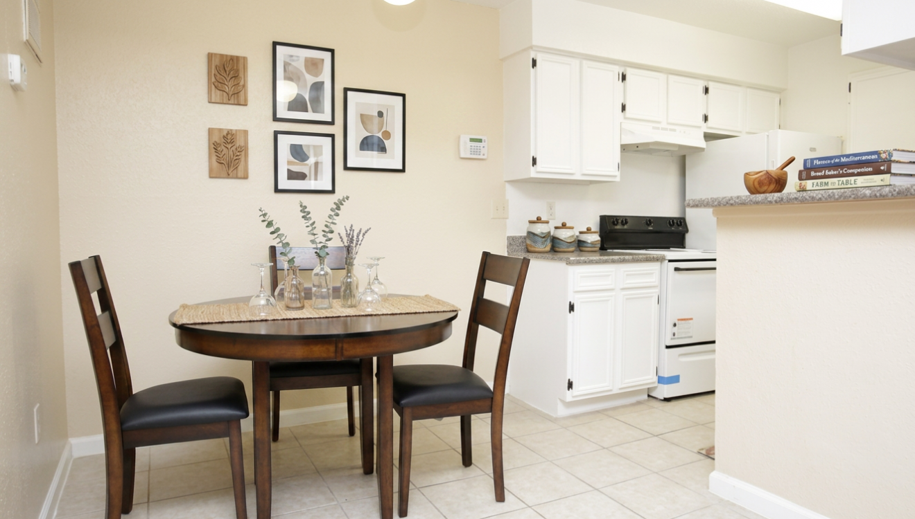Dining area with round wood table at Falls of Kirkwood Houston apartments